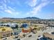 An aerial view of a community with mountain views and modern building, with ample parking space at 4260 Vornsand Dr, Las Vegas, NV 89115