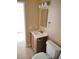 Bathroom with wood vanity, tile flooring, and standard toilet at 4260 Vornsand Dr, Las Vegas, NV 89115