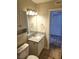 Bathroom features a single granite vanity, tile flooring and linen cabinet at 4260 Vornsand Dr, Las Vegas, NV 89115