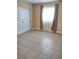 Bedroom featuring natural light, tile floors, and bi-fold closet door at 4260 Vornsand Dr, Las Vegas, NV 89115