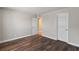 Bright bedroom featuring wood-look flooring, neutral walls, and two separate closet doors at 4260 Vornsand Dr, Las Vegas, NV 89115