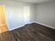 View of neutral bedroom, dark wood floor, and white door at 4260 Vornsand Dr, Las Vegas, NV 89115
