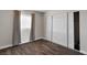 Bedroom showcasing wood-look floors, white trim, and a spacious closet with sliding doors at 4260 Vornsand Dr, Las Vegas, NV 89115
