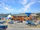 View of the charming multi-Gathering home and fenced parking area under a beautiful blue sky at 4260 Vornsand Dr, Las Vegas, NV 89115
