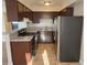 Galley kitchen featuring tile flooring, stainless steel refrigerator, and granite countertops at 4260 Vornsand Dr, Las Vegas, NV 89115