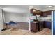 Spacious living area with updated flooring adjacent to the modern kitchen with granite countertops at 4260 Vornsand Dr, Las Vegas, NV 89115