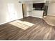 Bright living room area with wood-like flooring and a view into the kitchen at 4260 Vornsand Dr, Las Vegas, NV 89115