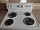Close up of a white electric stove top with four burners at 4260 Vornsand Dr, Las Vegas, NV 89115