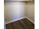 Spacious walk-in closet with custom shelving and hardwood floors at 4260 Vornsand Dr, Las Vegas, NV 89115