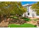 Backyard with lush greenery, trees, and a whimsical putting green at 43 Grey Feather Dr, Las Vegas, NV 89135