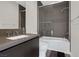 Modern bathroom with a shower-over-tub and neutral-tone tiling at 43 Grey Feather Dr, Las Vegas, NV 89135