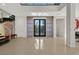 Bright foyer featuring modern staircase, tile flooring, and stylish entry doors at 43 Grey Feather Dr, Las Vegas, NV 89135