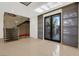 Bright foyer featuring modern staircase, tile flooring, and stylish entry doors at 43 Grey Feather Dr, Las Vegas, NV 89135