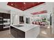 Open kitchen layout featuring a large island with cooktop, bar seating, and stainless appliances at 43 Grey Feather Dr, Las Vegas, NV 89135