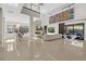 Open-concept living room with high ceilings, modern decor, and tile flooring throughout at 43 Grey Feather Dr, Las Vegas, NV 89135