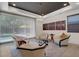 Bright living room with modern furnishings, a large window with backyard view, and unique light fixture at 43 Grey Feather Dr, Las Vegas, NV 89135