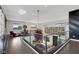 Second floor loft area featuring glass railings, stylish seating, and modern art at 43 Grey Feather Dr, Las Vegas, NV 89135