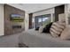 Well-appointed main bedroom with a cozy fireplace, TV, and balcony, with elegant furnishings at 43 Grey Feather Dr, Las Vegas, NV 89135