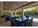 Elegant outdoor dining area next to the pool with comfortable lounge seating at 43 Grey Feather Dr, Las Vegas, NV 89135