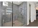 Modern bathroom features a large glass enclosed walk-in shower with marble tiling and fixtures at 43 Grey Feather Dr, Las Vegas, NV 89135