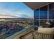 Balcony with seating and expansive views of the city skyline at dusk at 4575 Dean Martin Dr # 2400, Las Vegas, NV 89103