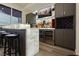 Modern home bar with backlit countertop, wine fridge, cabinets, and shelving at 4575 Dean Martin Dr # 2400, Las Vegas, NV 89103