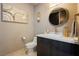 Elegant powder room with modern vanity, gold accents, and decorative art at 4575 Dean Martin Dr # 2400, Las Vegas, NV 89103