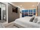 A spacious bedroom with large window offers city views, along with built-in storage and television at 4575 Dean Martin Dr # 2400, Las Vegas, NV 89103