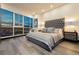 Serene bedroom with city views, a tufted headboard, and stylish decor at 4575 Dean Martin Dr # 2400, Las Vegas, NV 89103