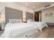This bedroom features two beds with grey tufted headboards and light wood flooring at 4575 Dean Martin Dr # 2400, Las Vegas, NV 89103