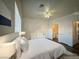 Bright bedroom featuring neutral décor, a ceiling fan, and a bathroom entrance at 4730 E Craig Rd # 1172, Las Vegas, NV 89115