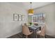Dining room features modern light fixture and a four-chair dining set at 4730 E Craig Rd # 1172, Las Vegas, NV 89115