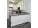 Well-lit kitchen boasts granite counters, stainless steel refrigerator, and sleek white cabinetry at 4730 E Craig Rd # 1172, Las Vegas, NV 89115