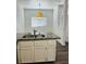 Cozy kitchen island featuring granite countertops and cabinets, illuminated by a pendant light at 4730 E Craig Rd # 1172, Las Vegas, NV 89115