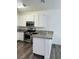 Modern kitchen with stainless steel oven, microwave, granite countertop, and white cabinets at 4730 E Craig Rd # 1172, Las Vegas, NV 89115