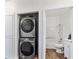 Laundry closet with gray stacked washer and dryer next to bathroom at 4730 E Craig Rd # 1172, Las Vegas, NV 89115