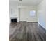 Living room with a fireplace, wood-look floors, and natural light at 4730 E Craig Rd # 1172, Las Vegas, NV 89115