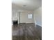 Living room with a fireplace, wood-look floors, and natural light at 4730 E Craig Rd # 1172, Las Vegas, NV 89115