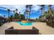 Relaxing community pool area surrounded by palm trees and comfortable seating at 4730 E Craig Rd # 1172, Las Vegas, NV 89115