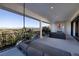 Enjoy an outdoor balcony with a daybed, seating area, and scenic views of the surrounding landscape and pool at 48 Augusta Canyon Way, Las Vegas, NV 89141