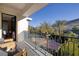 Balcony featuring outdoor seating with views of the desert landscape and tennis court at 48 Augusta Canyon Way, Las Vegas, NV 89141