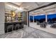 Stylish bar area leading to an outdoor lounge area with a pool view at 48 Augusta Canyon Way, Las Vegas, NV 89141