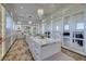 Elegant walk-in closet features custom shelving, drawers, two chandeliers, and a center island at 48 Augusta Canyon Way, Las Vegas, NV 89141