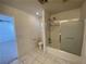 Bathroom with a shower-tub combo, tile floor, and modern fixtures at 4912 Hostetler Ave, Las Vegas, NV 89131