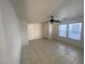 Spacious living room with tile floors, natural light, and a modern ceiling fan at 4912 Hostetler Ave, Las Vegas, NV 89131