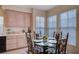 Dining area with a glass table and seating for six, next to the kitchen at 533 Tuscany View St, Las Vegas, NV 89145