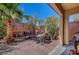 Relaxing backyard featuring brick pavers, palm trees, a grill and an umbrella at 5465 Buckeye Lake St, Las Vegas, NV 89122