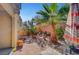 Private backyard with brick-paved patio, desert landscaping and mature palm, perfect for outdoor entertaining at 5465 Buckeye Lake St, Las Vegas, NV 89122