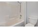 A bright bathroom features white tiled walls and shower over tub at 58 Desert Castle Ct, Henderson, NV 89012