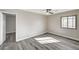 Bedroom featuring wood-look flooring, large windows, and neutral paint, providing a serene atmosphere at 58 Desert Castle Ct, Henderson, NV 89012